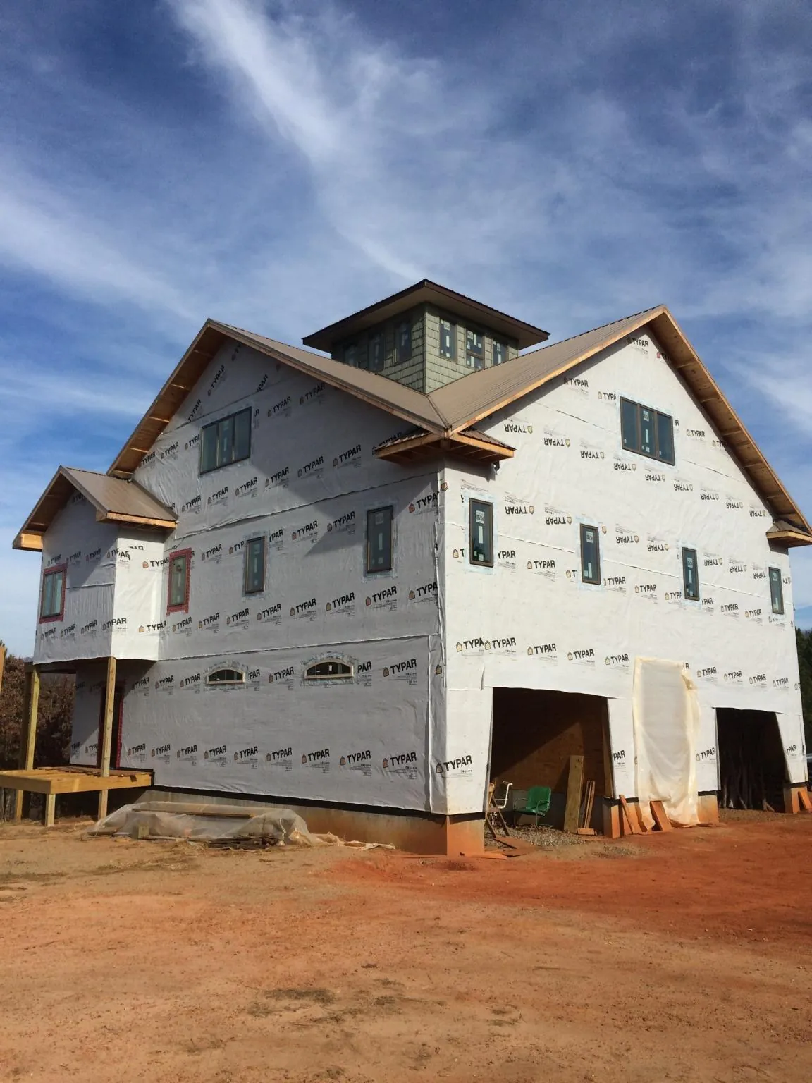 New two story house under construction with a cupola and gabled roofs in Cooperstown